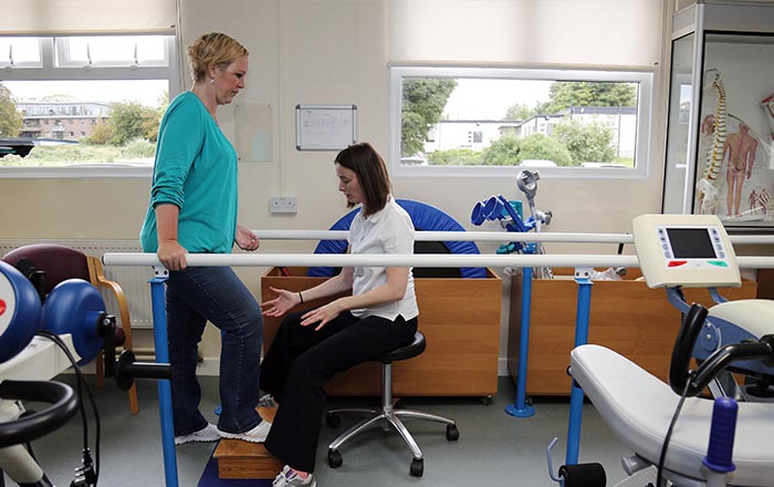 Service user and NRH staff performing rehabilitation exercises